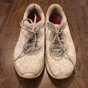 Gray and white patterned Nike running shoes
